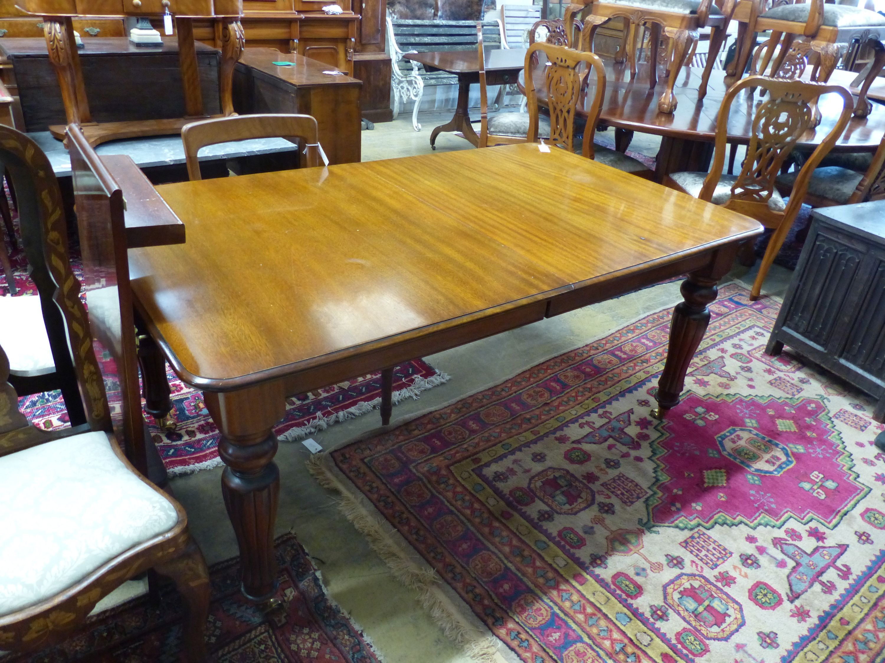 A Victorian mahogany extending dining table (one additional leaf), 250cm extended, width 100cm, height 76cm